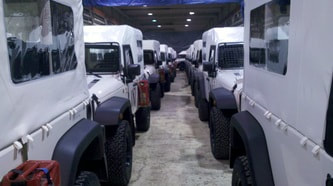 White J8 Troop Carrier Jeeps in Warehouse