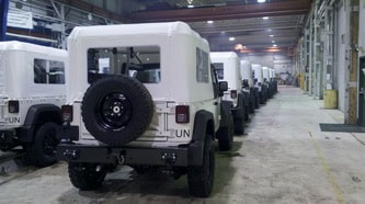 J8 Troop Carrier Jeeps Parked in Warehouse