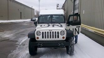 UN J8 Troop Carrier Jeep Parked Outside